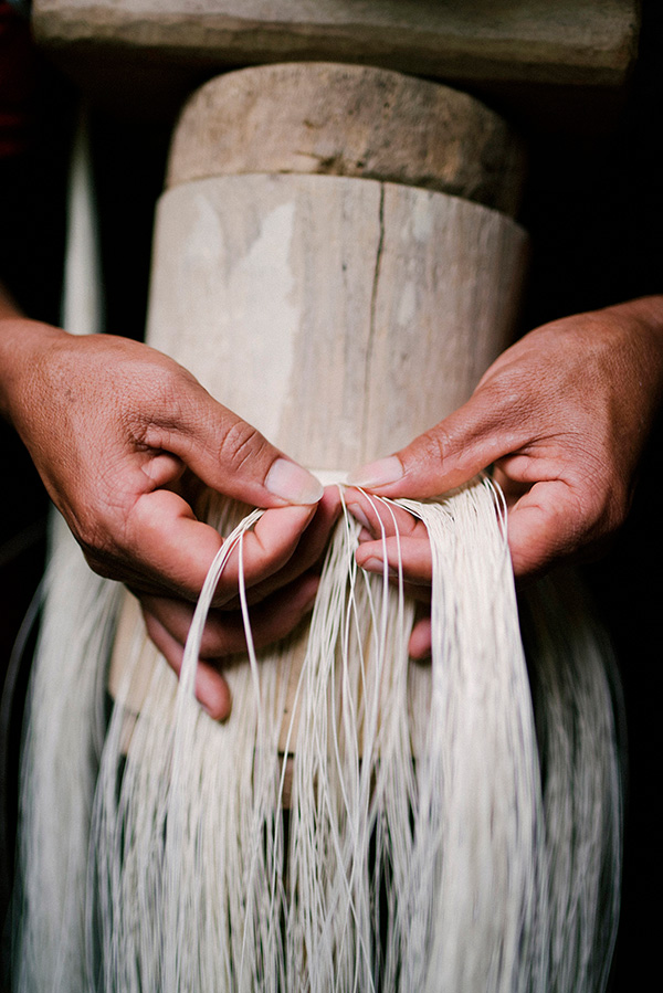 Domingo Carranza weaving toquilla straw on the weaving bench