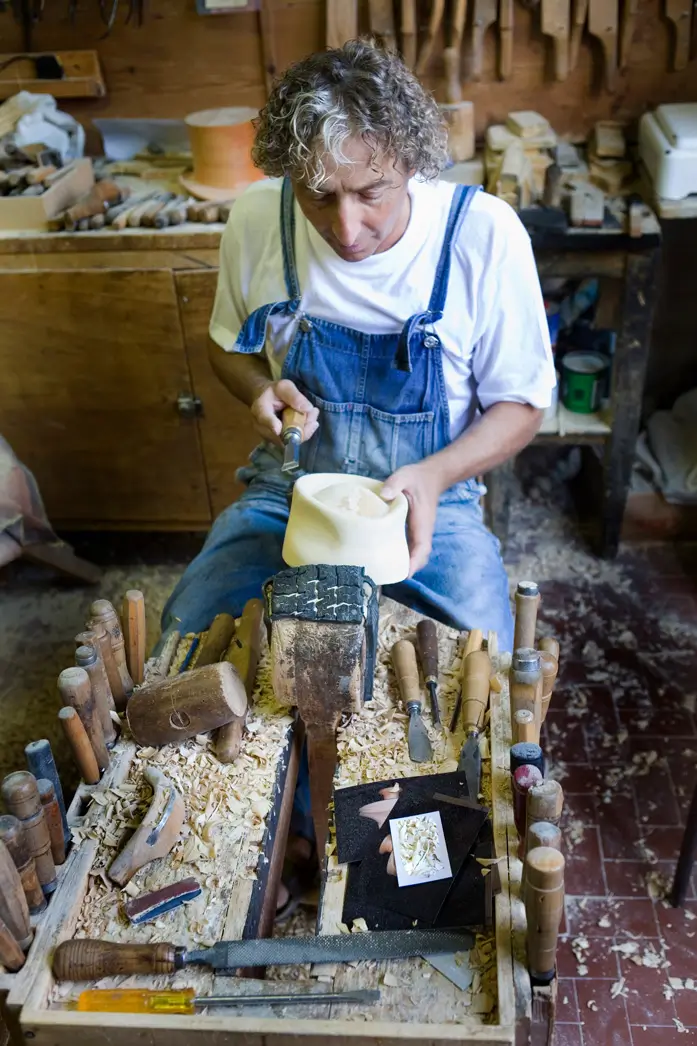 Man carving the wooden last for Montecristi Panama hats by Domingo Carranza. Each last has an exclusive design