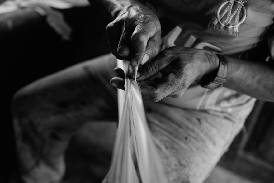 Domingo Carranza working teh toquilla straw at his workshop, process for weaving a Montecristi Panama Hat